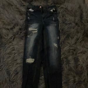 Dark blue high rise pants with holes up the legs.